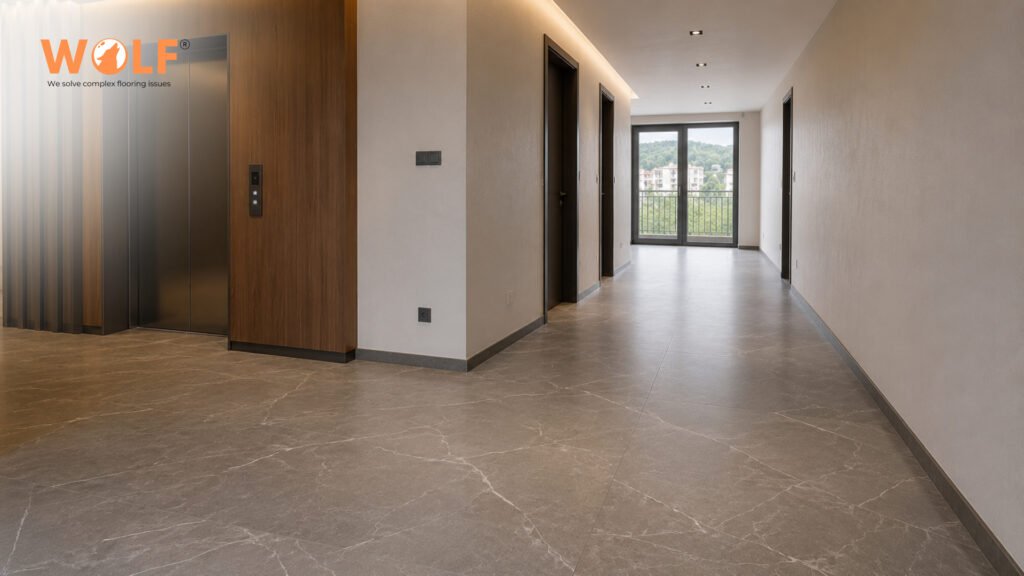 Large format porcelain tiles in residential building corridor showing elongated hallway perspective
