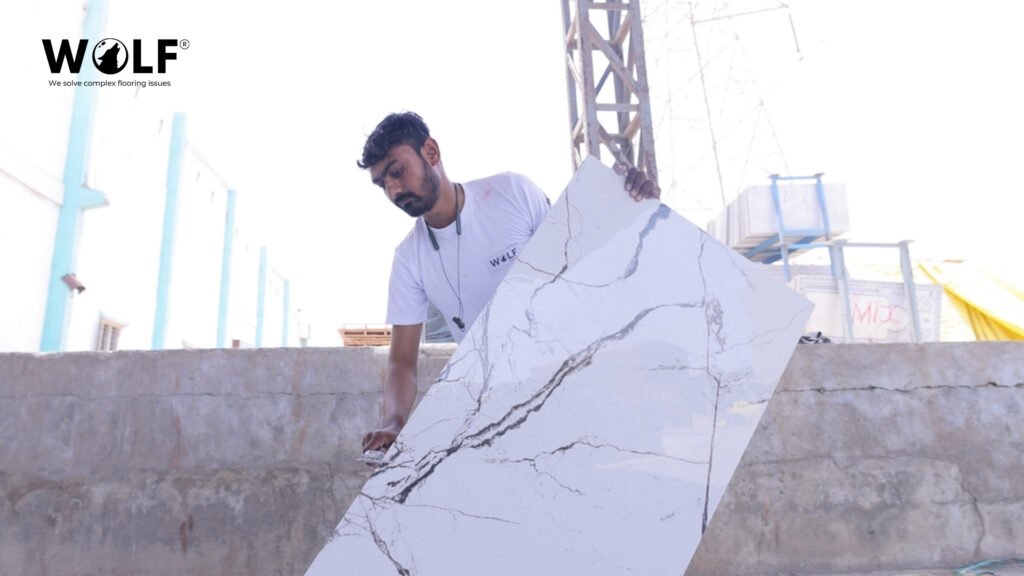 Checking a Wolf porcelain tile sample for shade, edge and surface finish